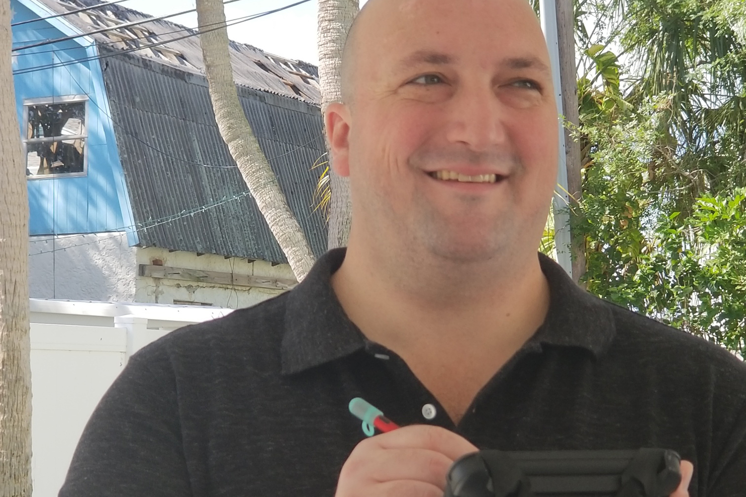 a man holding a black object in his hands