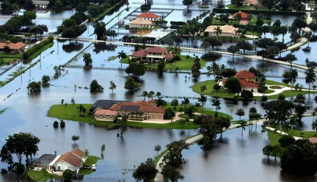 a flooded area with houses and trees in it