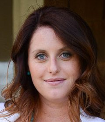 a woman with blue eyes and a white shirt