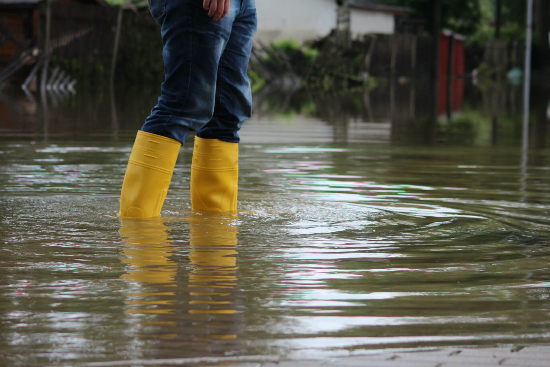 a person wearing yellow boots standing in water