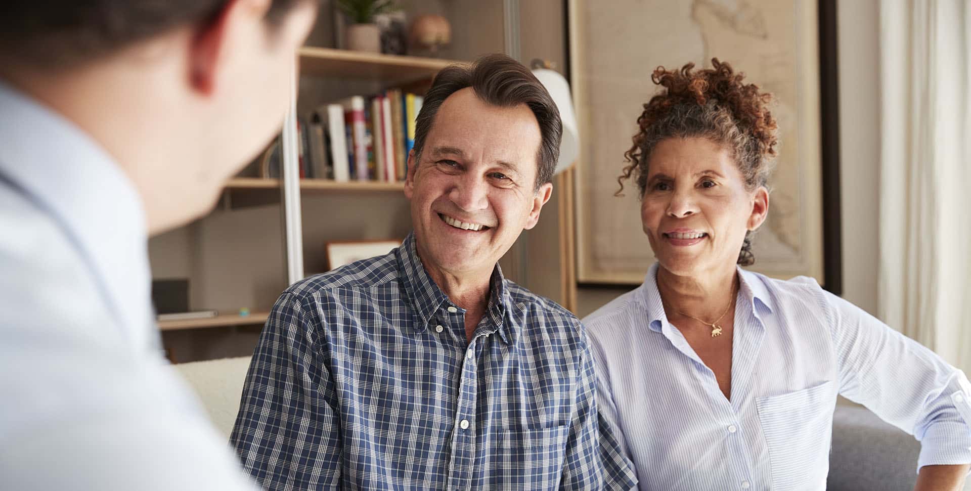 Senior Couple Meeting With Male Financial Advisor At Home