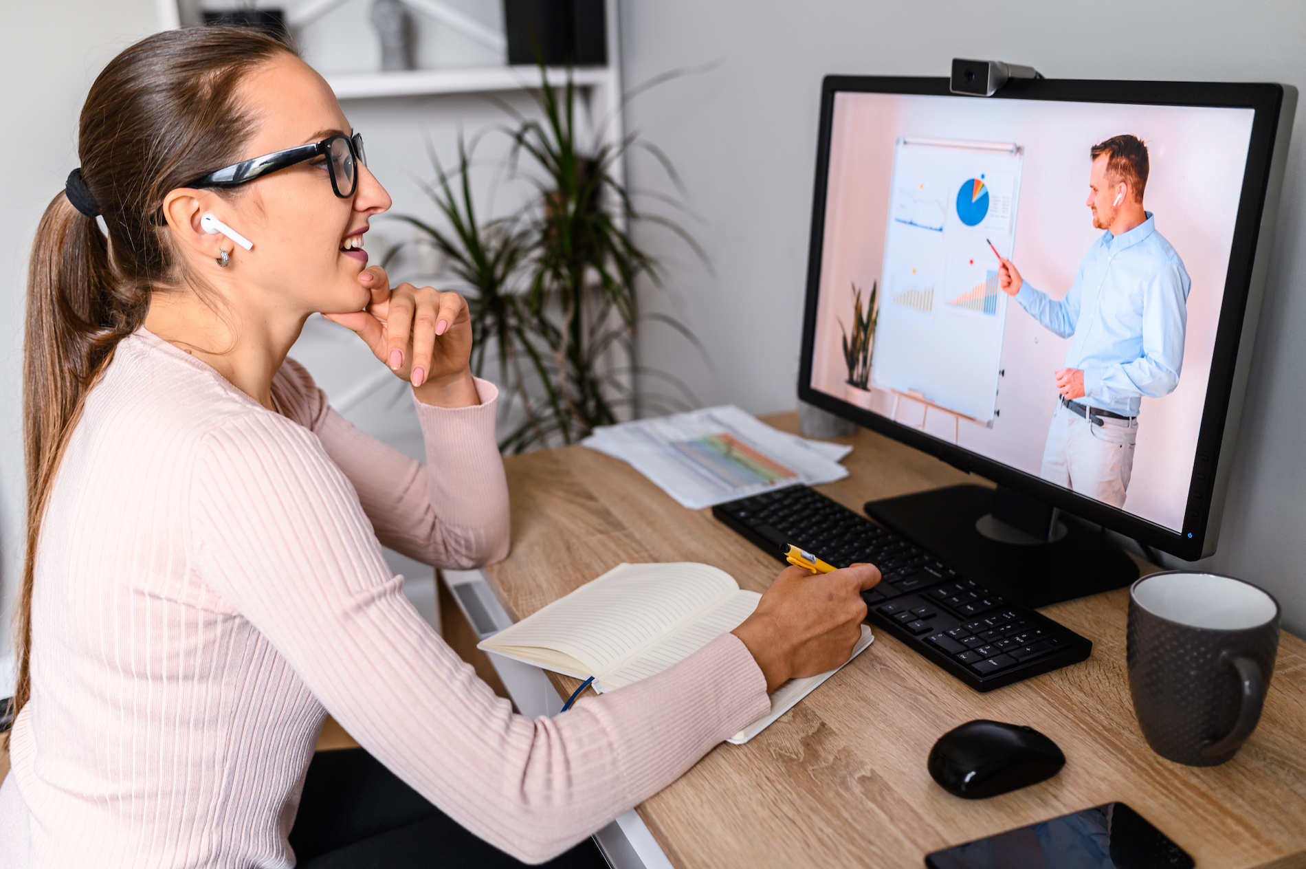 a woman sitting in front of a computer screen