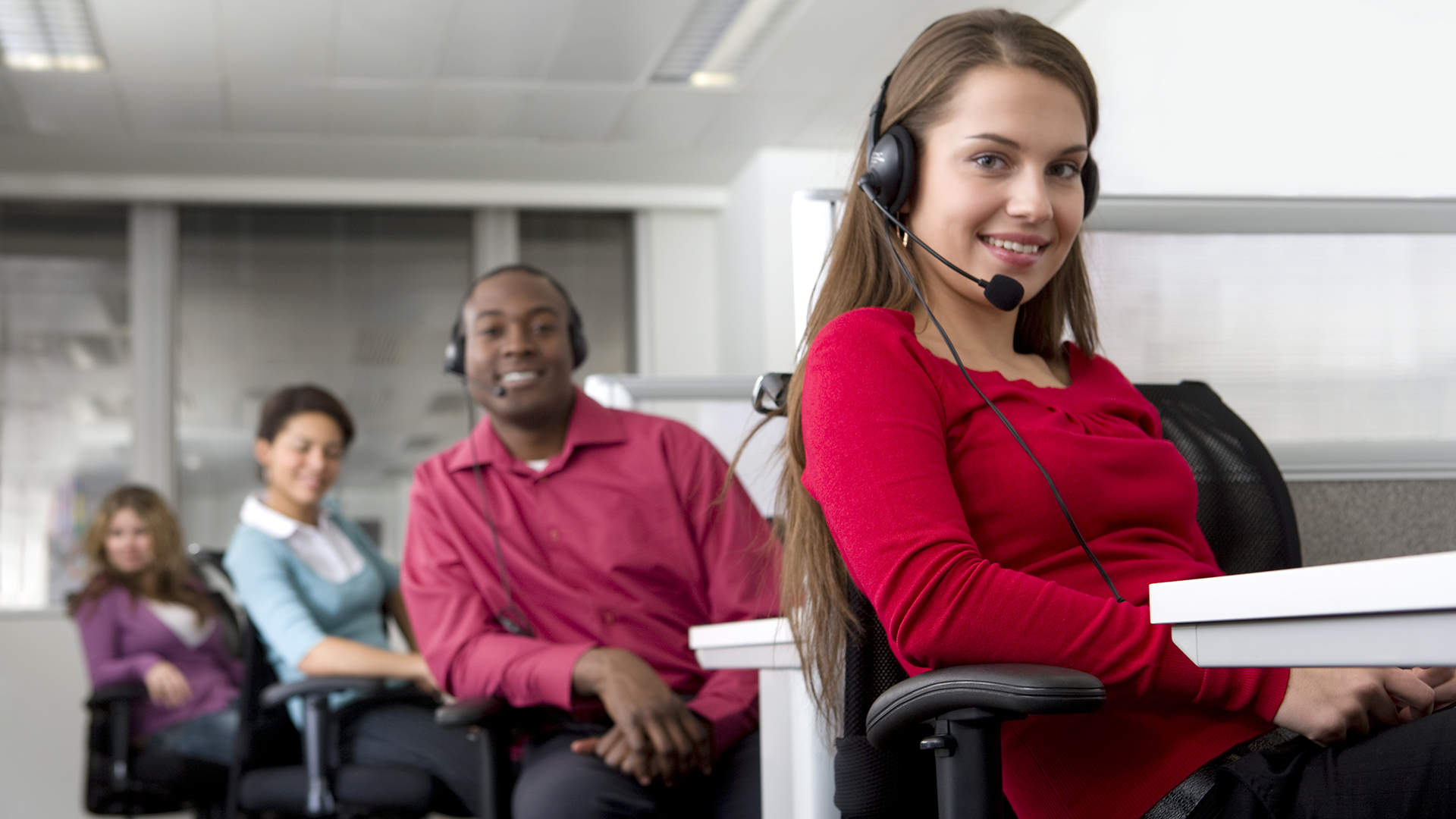 a woman sitting in a chair with headphones on