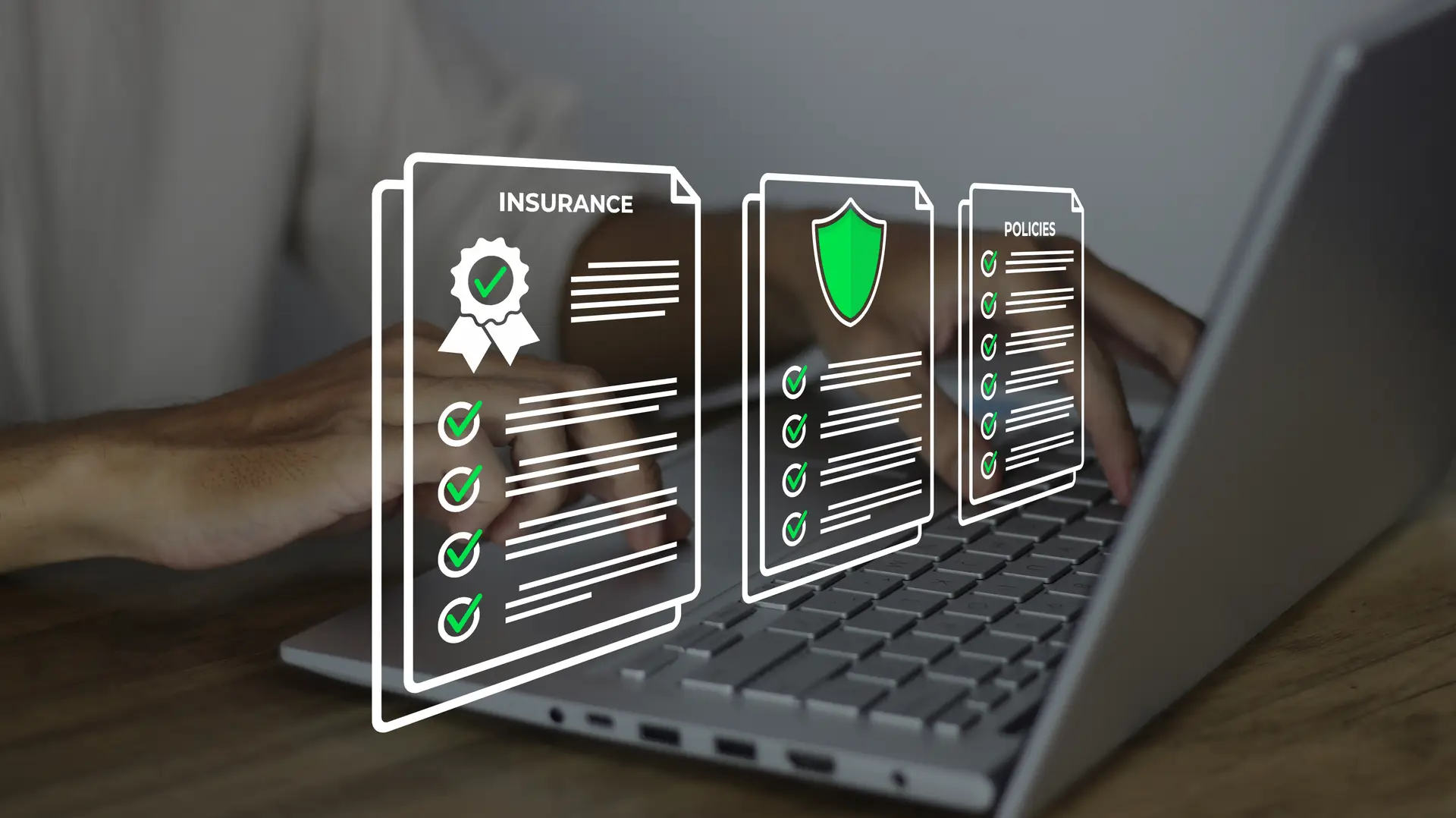 Insurance policy and claims documents shown over a laptop