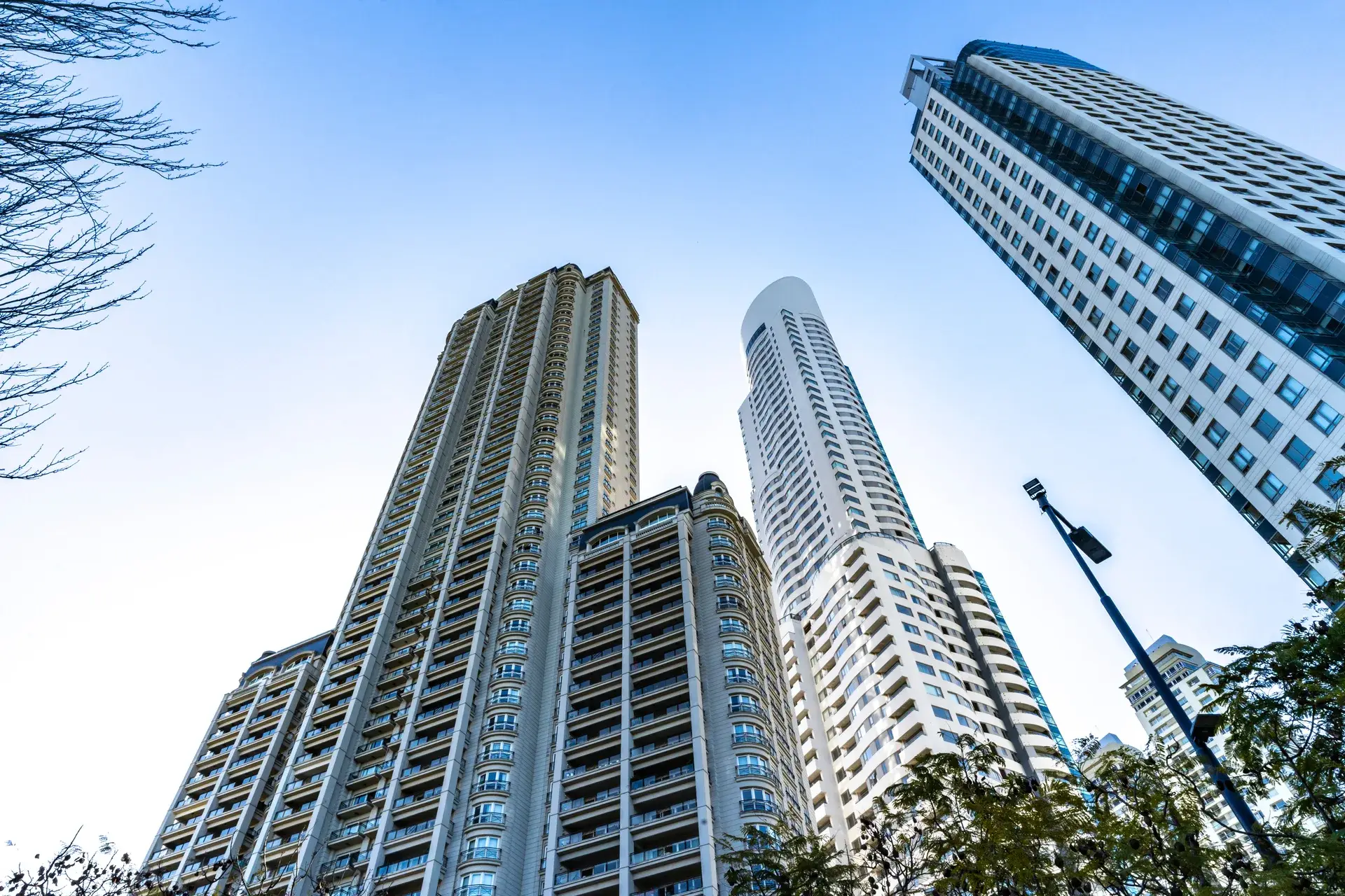 Low-angle view of corporate high-rise buildings against a blue sky