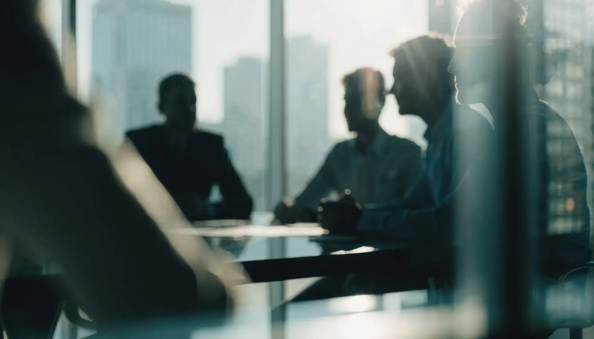 professionals meeting by a window overlooking the city skyline